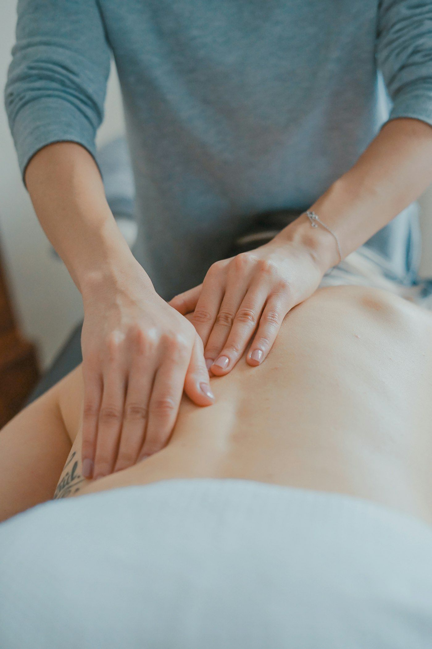 A Registered Massage Therapist treating a client’s back